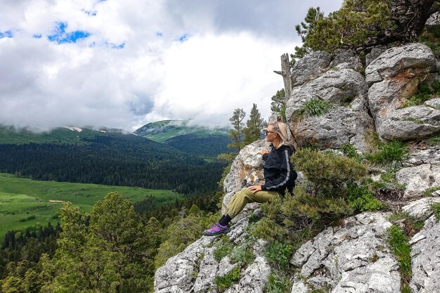 A girl with a view of the Alpine meadows The LagoNaki plateau in Adygea Russia 2021