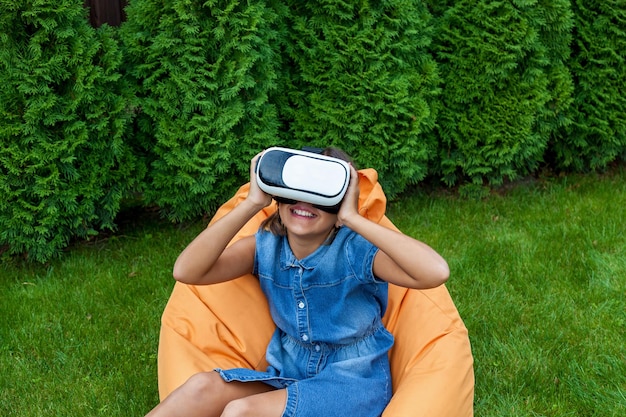 Girl with virtual reality glasses in the park