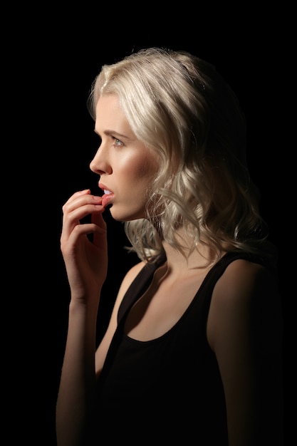 Girl with white hair and natural makeup bites her nails