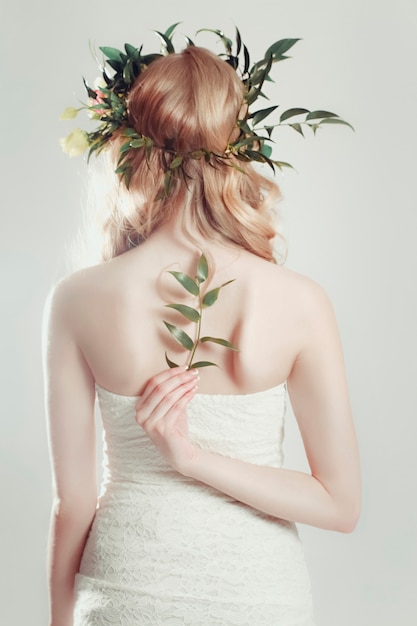 Girl with a wreath of flowers on her head 