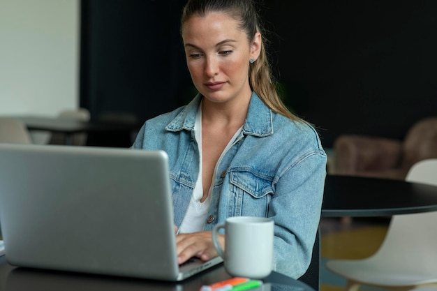 Girl working on laptop in trendy coffee shop stock photo