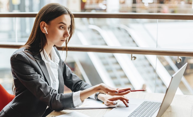 Girl works on a laptop in the workplace Businesswoman is shocked by the crisis Successful woman creates a startup and makes decisions