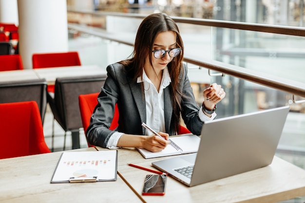 Girl works on a laptop in the workplace