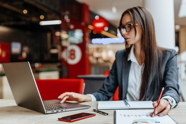 Girl works on a laptop in the workplace