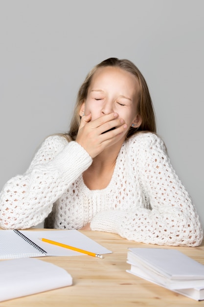 Girl yawning while studying