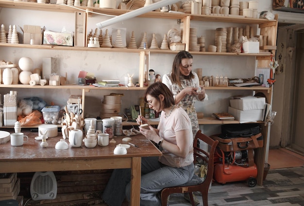 Girls artists are working in a workshop on the restoration and manufacture of wooden toys