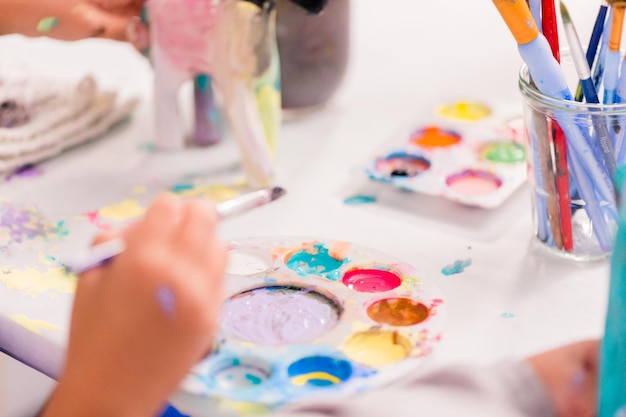 Girls decorating their small paper mache unicorns figurines at the unicorn extravaganza party.