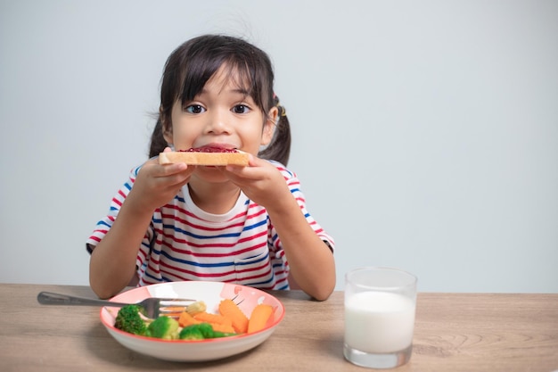 Girls eat breakfast on the table in the living room