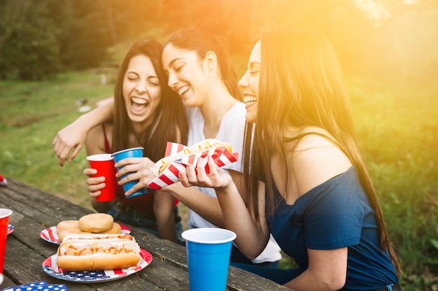 Girls having picnic on sunset