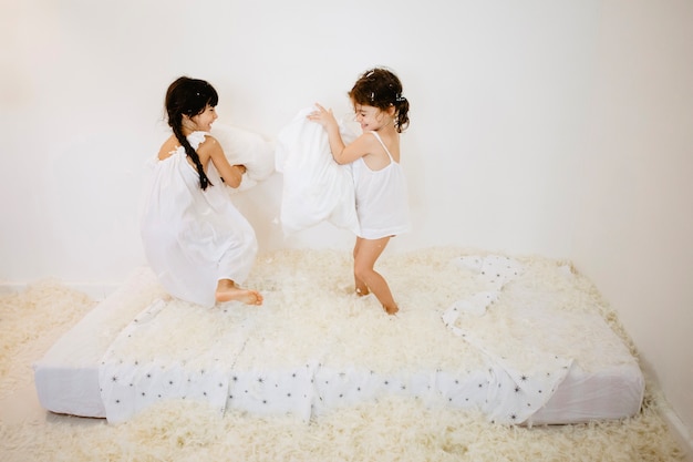 Girls having pillows fight