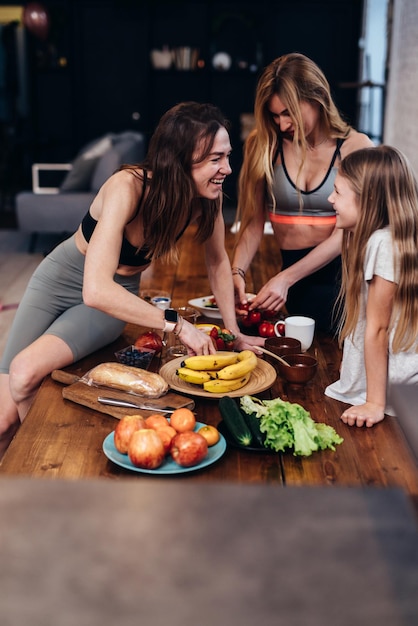 Girls in the kitchen talking cooking easy meals of fruits and vegetables