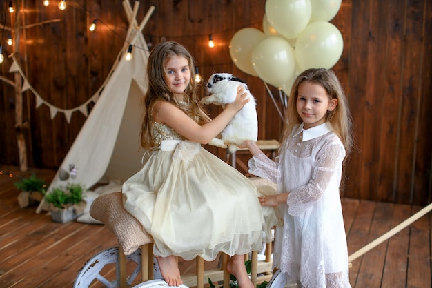 girls playing with a rabbit easter theme