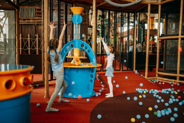 Girls plays air gun machine, children game center