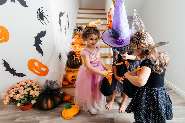 Girls receiving bunch of candies during halloween trick or treating