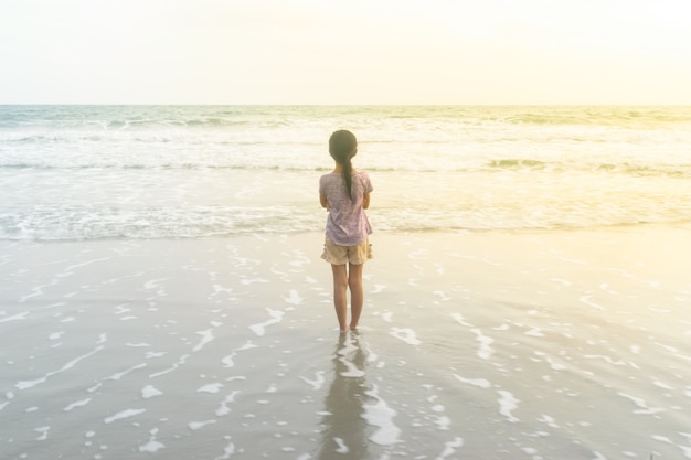 The girls stood looking at the sea on a vacation