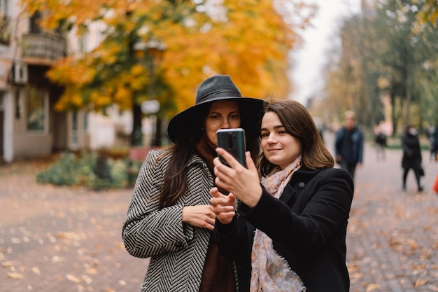 Girls using phone in the park