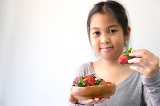 Girls with fresh red strawberries, healthy food