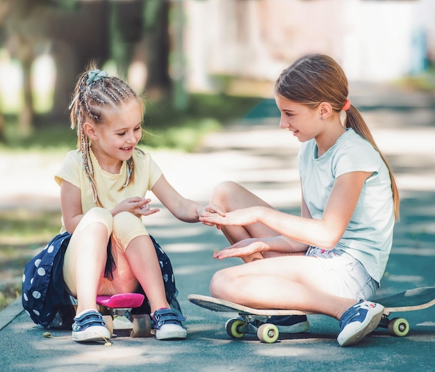 Girls with skateboards in the park