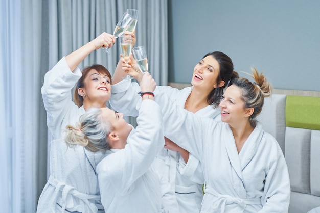 Girls with wine at spa party in the hotel