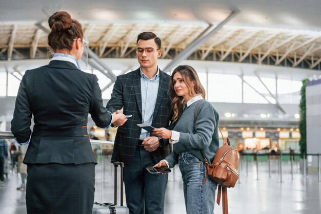 Giving the documents Young couple is in the airport together