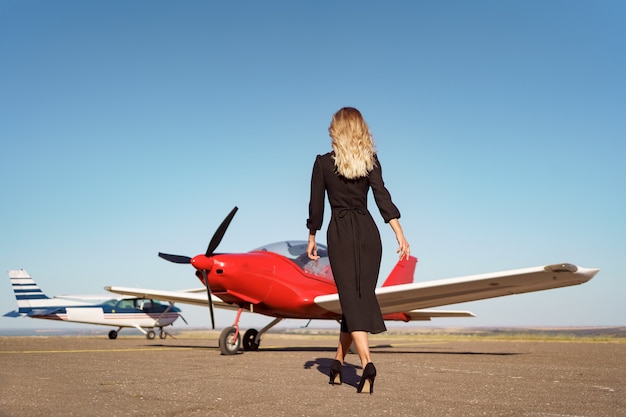 Glamorous woman posing on plane