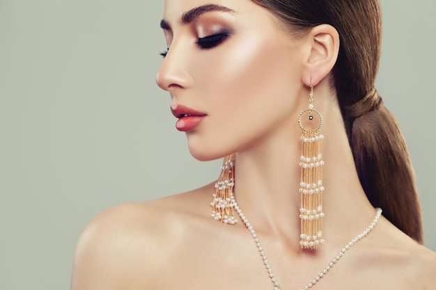 Glamorous Woman with Jewelry Silver Earrings with White Pearls on Banner Background