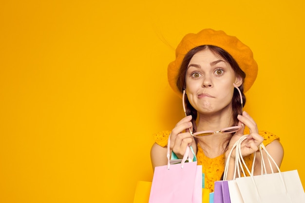 Glamorous woman yellow dress shopping fun isolated background