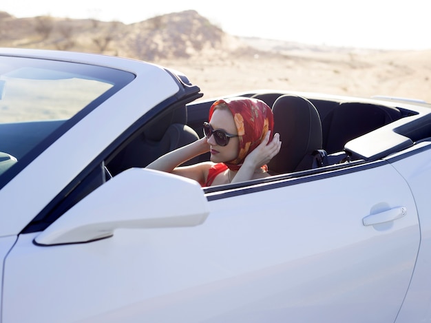 Glamour woman in scarf drive convertible car