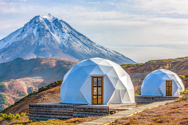 Glamping house and volcano rural landscape tent houses in kamchatka peninsula selective focus