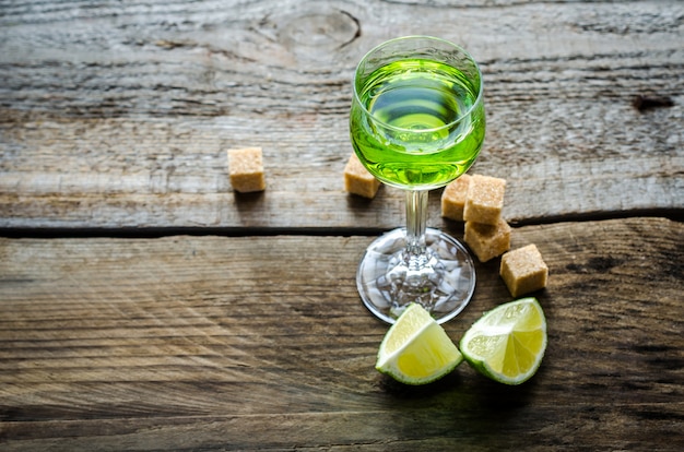 Glass of absinthe with lime and sugar cubes