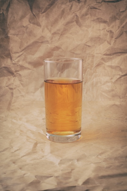 A glass of apple juice with apples