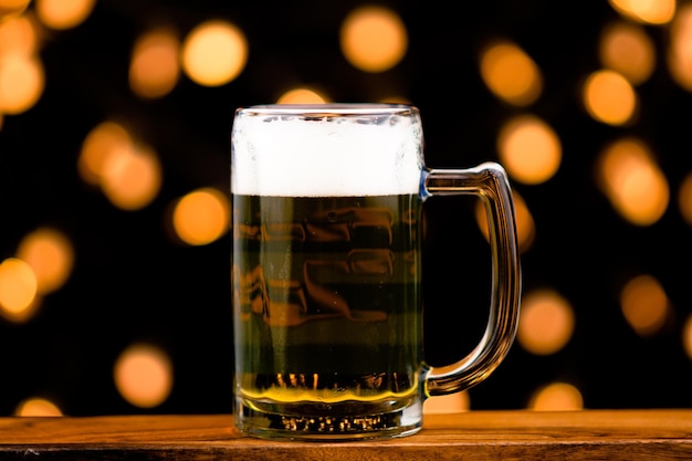 Glass of beer alcoholic drink isolated bokeh background light to party