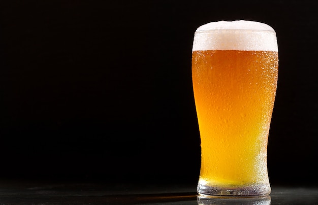 Glass of beer on a dark background