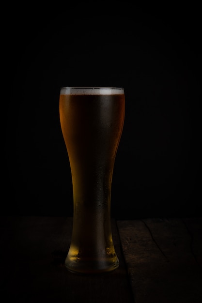 Glass of beer on dark background