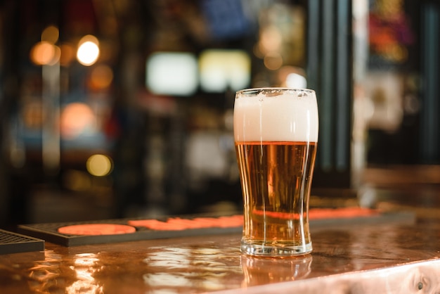 A glass of beer in a popular bar