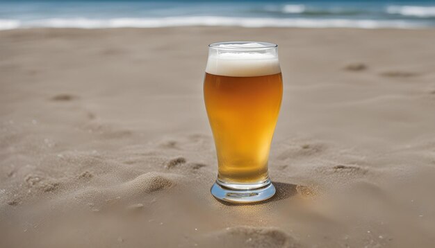 a glass of beer sits on the sand at the beach