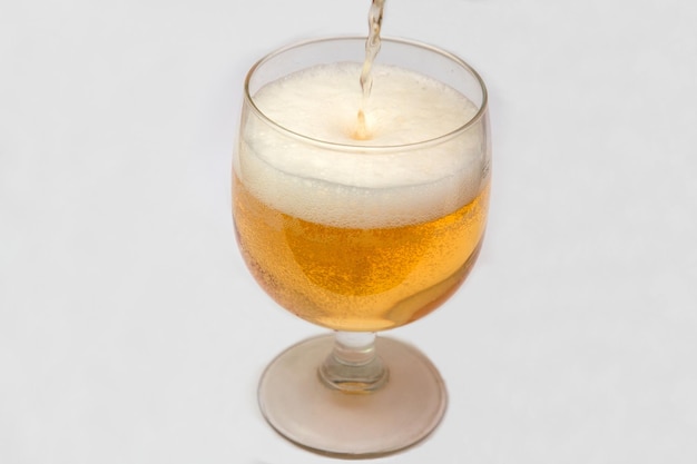 Glass of beer on white background