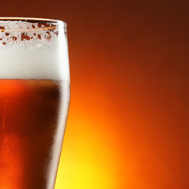 Glass of beer with froth close-up