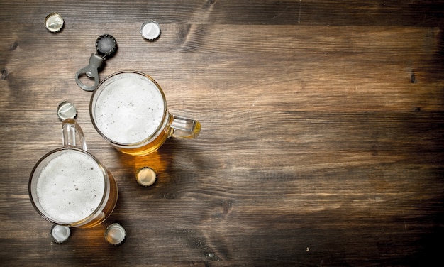 Glass of beer with stoppers and a bottle opener