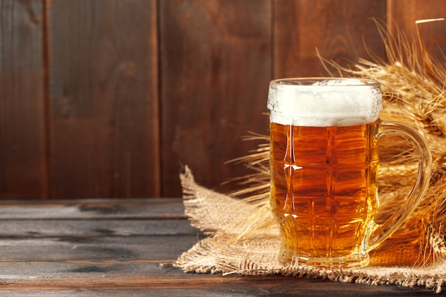 Glass beer on wood background