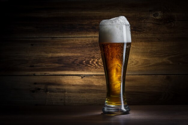 Glass of beer on a wooden background