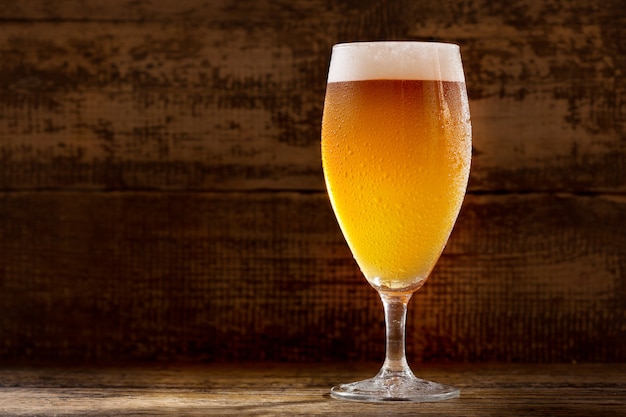 Glass of beer on a wooden table