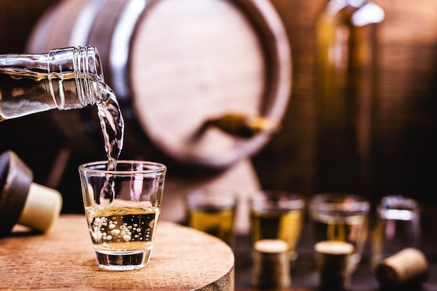 Glass being served with Drink, known as CachaÃÂÃÂÃÂÃÂ§a, "pinga", distilled sugar cane. Name given to cognac produced in Brazil.