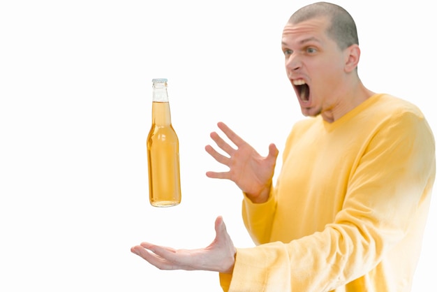 A glass bottle of beer flying above the men's hands isolated on a white background A screaming man Amazed Adult Drink Emotion Excited Expression Amazement Bar Funny Lager Person