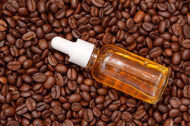 Glass bottle with coffee essential oil and coffee beans