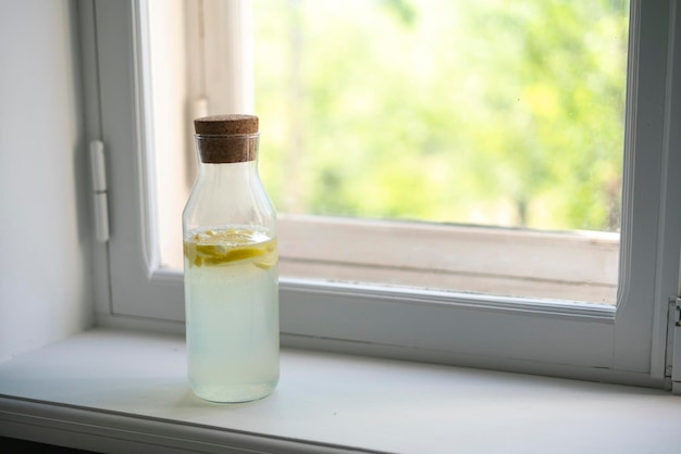 A glass bottle with cold summer lemon fresh