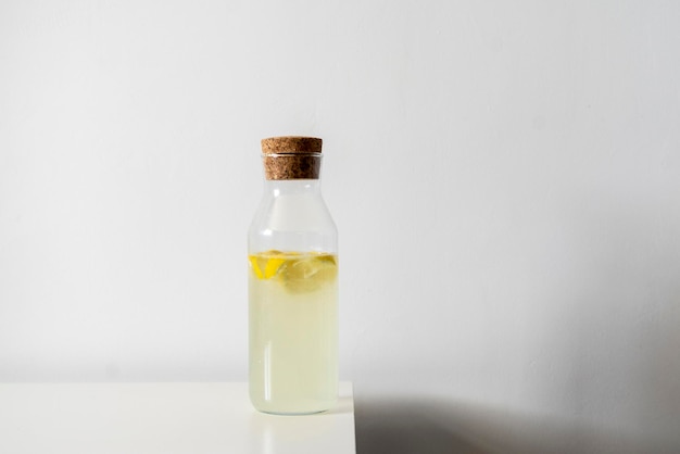 A glass bottle with cold summer lemon fresh