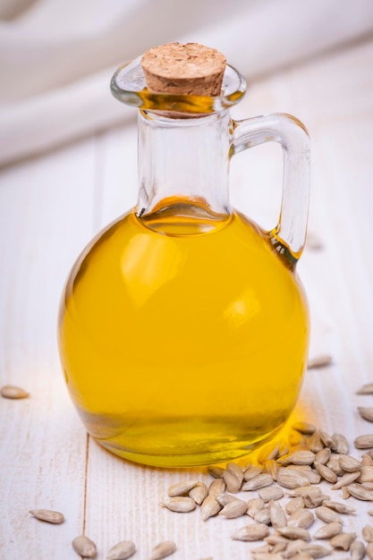 Glass bottle with yellow oily liquid Closeup sunflower vegetable oil