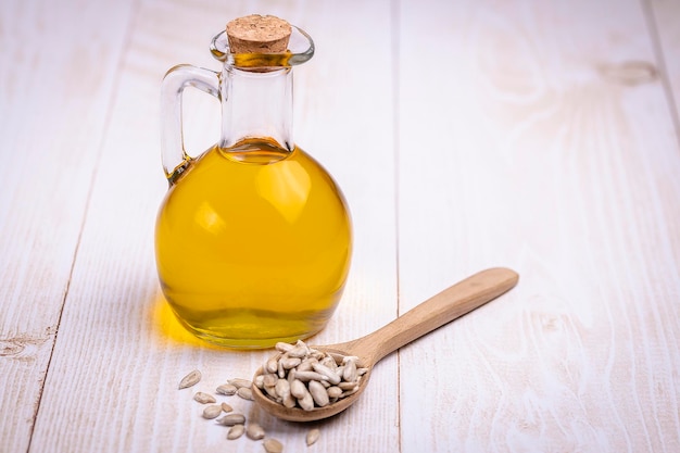 Glass bottle with yellow oily liquid Closeup sunflower vegetable oil