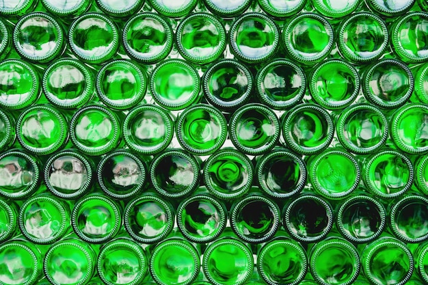 Glass bottles green Green glass bottles of beer Wall formed by green bottles Green bottles background Empty Glass Bottle with Lighting